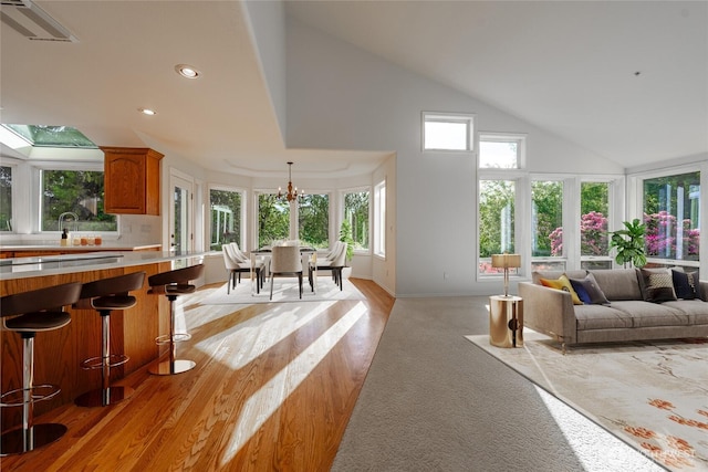 5501 55th St SE, Auburn, WA 98092 - living room featuring high vaulted ceiling, light wood finished floors, recessed lighting, and a chandelier