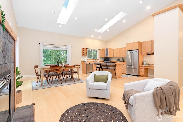 137 Sudden Valley Dr, Bellingham, WA 98229 - living room with a skylight, light wood-type flooring, high vaulted ceiling, recessed lighting, and baseboards