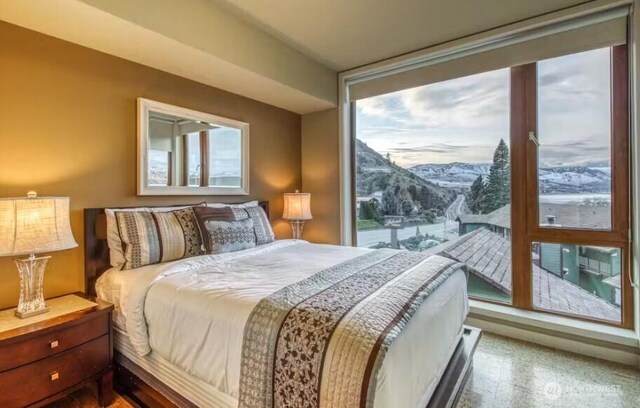 2220 W Woodin Ave Unit 303, Chelan, WA 98816 - bedroom featuring a mountain view and multiple windows