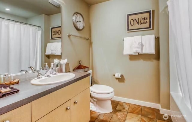 2220 W Woodin Ave Unit 303, Chelan, WA 98816 - bathroom featuring baseboards, curtained shower, vanity, and toilet