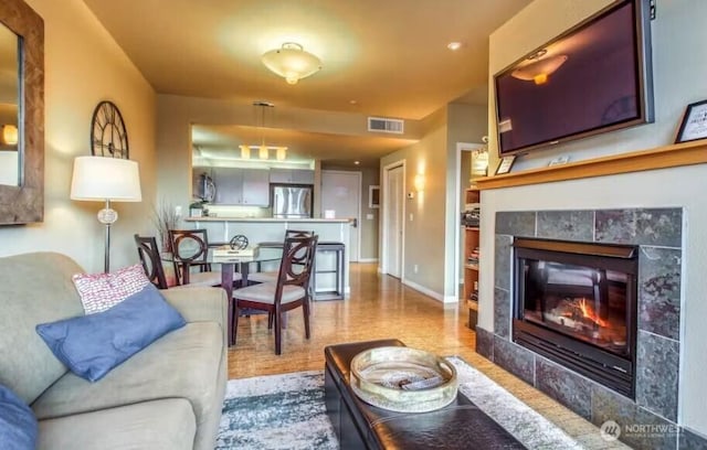 2220 W Woodin Ave Unit 303, Chelan, WA 98816 - living room featuring a tile fireplace and baseboards