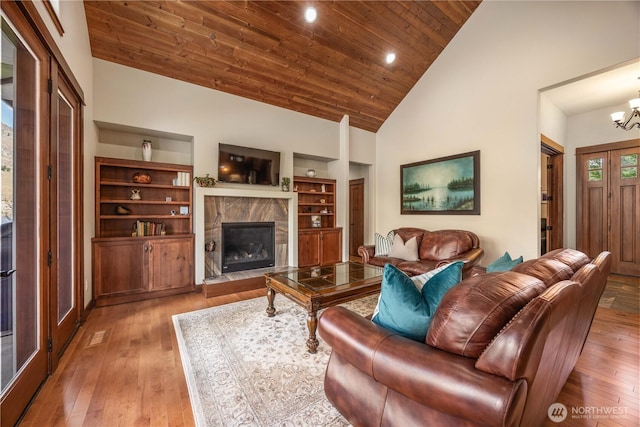 35 N Shore Dr, Orondo, WA 98843 - living room with wooden ceiling, wood-type flooring, a premium fireplace, a chandelier, and high vaulted ceiling