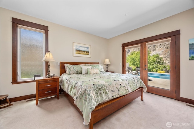 35 N Shore Dr, Orondo, WA 98843 - bedroom featuring light colored carpet, access to exterior, french doors, and multiple windows