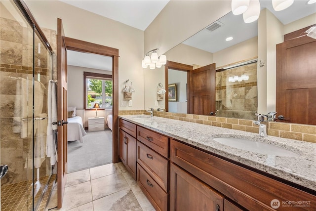 35 N Shore Dr, Orondo, WA 98843 - bathroom with a stall shower, double vanity, tile patterned flooring, ensuite bathroom, and tasteful backsplash
