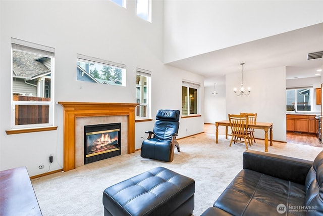 12032 38th Ave SE, Everett, WA 98208 - living area with a chandelier, light colored carpet, plenty of natural light, and a towering ceiling