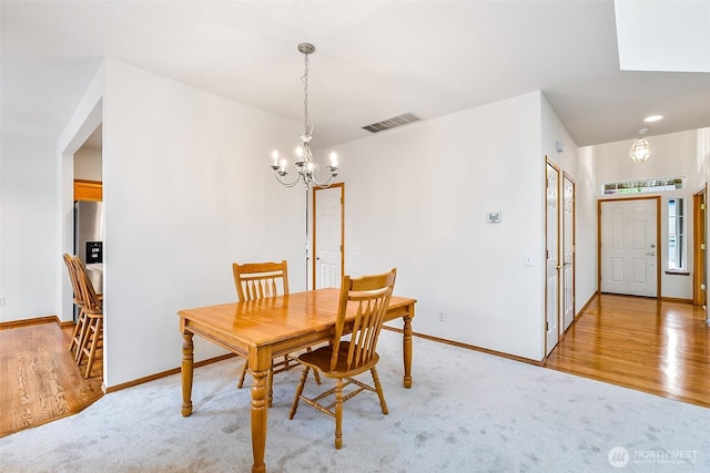 12032 38th Ave SE, Everett, WA 98208 - dining area with a chandelier, baseboards, light wood finished floors, and light colored carpet