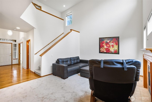 12032 38th Ave SE, Everett, WA 98208 - living room with a towering ceiling, stairs, carpet flooring, recessed lighting, and a fireplace