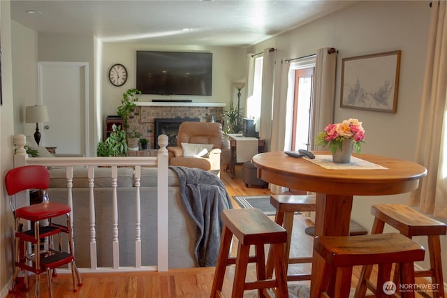 22015 SE 244th Pl, Maple Valley, WA 98038 - living area featuring a brick fireplace and wood finished floors