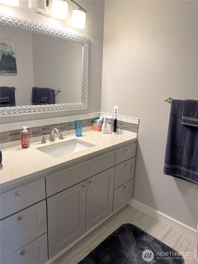22015 SE 244th Pl, Maple Valley, WA 98038 - bathroom featuring vanity, decorative backsplash, and baseboards
