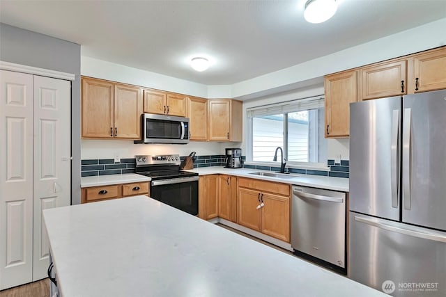 1131 115th St SW Unit M2, Everett, WA 98204 - kitchen with stainless steel appliances, a sink, light countertops, and light brown cabinetry