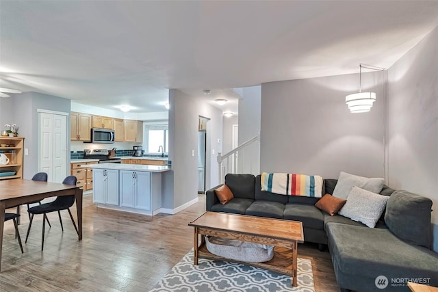 1131 115th St SW Unit M2, Everett, WA 98204 - living area featuring light wood finished floors, baseboards, and stairs