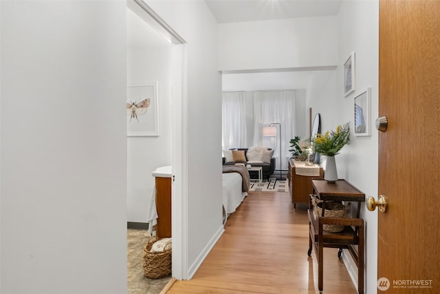 7 Harrison St Unit 26, Seattle, WA 98109 - hallway featuring light wood-style flooring and a baseboard heating unit