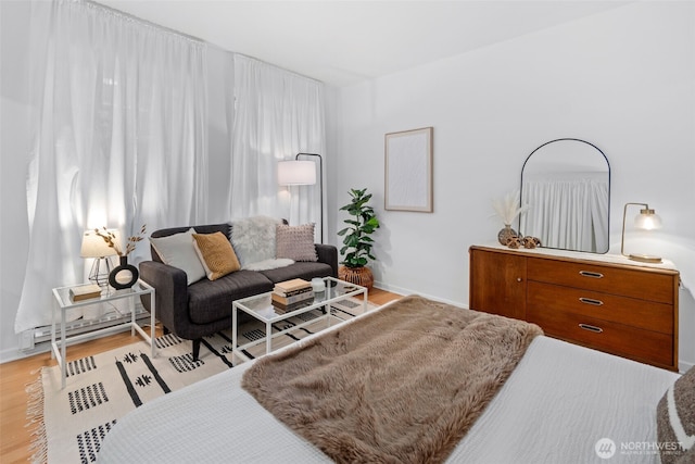 7 Harrison St Unit 26, Seattle, WA 98109 - bedroom featuring light wood-style floors, baseboards, and a baseboard heating unit