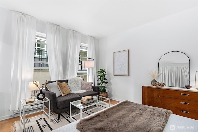 7 Harrison St Unit 26, Seattle, WA 98109 - living room featuring light wood-style flooring, baseboards, and baseboard heating