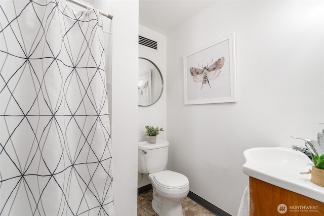 7 Harrison St Unit 26, Seattle, WA 98109 - full bathroom featuring vanity, a shower with curtain, toilet, and baseboards