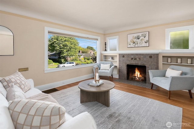 6813 17th Ave NE, Seattle, WA 98115 - living area with wood finished floors, a fireplace, baseboards, and crown molding