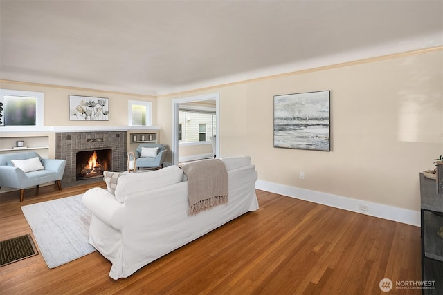 6813 17th Ave NE, Seattle, WA 98115 - living area with a fireplace, wood finished floors, and baseboards