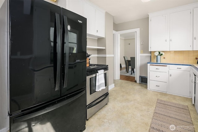 6813 17th Ave NE, Seattle, WA 98115 - kitchen featuring freestanding refrigerator, electric stove, white cabinetry, and backsplash