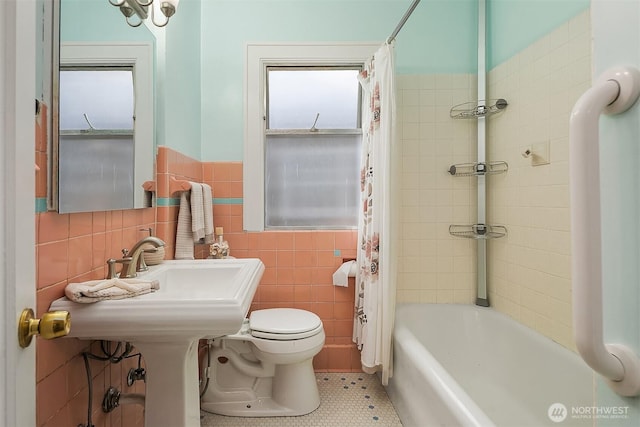 6813 17th Ave NE, Seattle, WA 98115 - full bathroom featuring tile walls, toilet, tile patterned flooring, shower / bathtub combination with curtain, and wainscoting