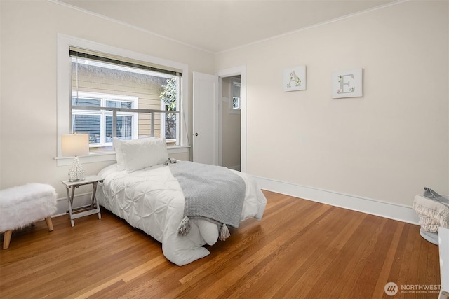 6813 17th Ave NE, Seattle, WA 98115 - bedroom with ornamental molding, wood finished floors, and baseboards