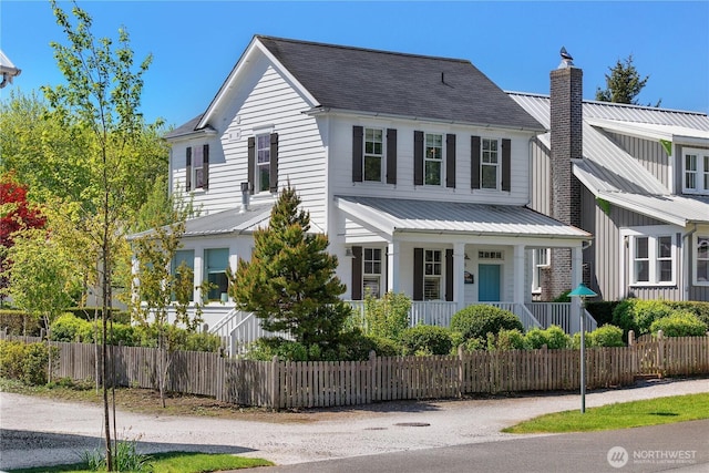 228 Meriweather St, Pacific Beach, WA 98571 - view of front of property with covered porch, a chimney, a fenced front yard, and metal roof
