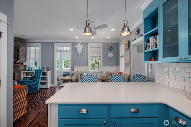 228 Meriweather St, Pacific Beach, WA 98571 - kitchen featuring open floor plan, light countertops, a peninsula, tasteful backsplash, and hanging light fixtures