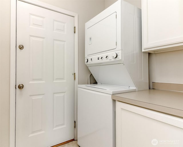 1002 9th Ave SE Unit C-201, Puyallup, WA 98372 - laundry room with stacked washer / drying machine and cabinet space