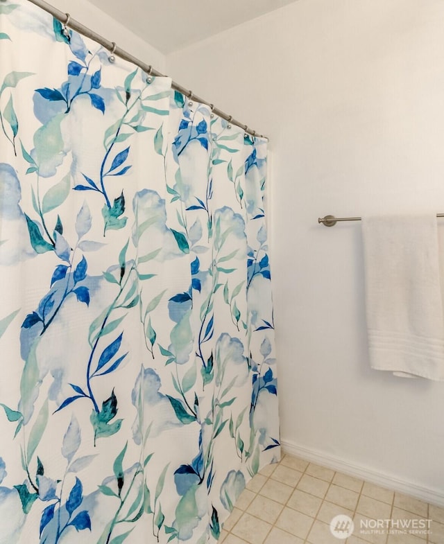 1002 9th Ave SE Unit C-201, Puyallup, WA 98372 - full bathroom featuring tile patterned floors, baseboards, and a shower with curtain