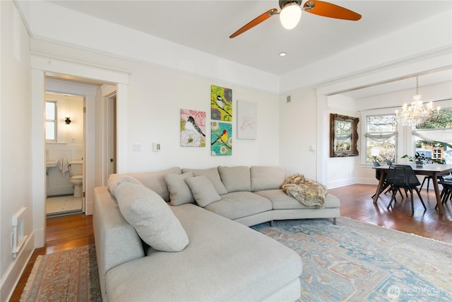 2011 E Cherry St, Seattle, WA 98122 - living area with a chandelier, wood finished floors, a ceiling fan, and baseboards