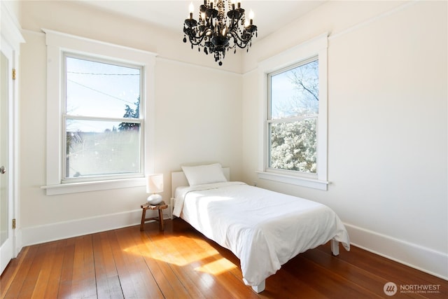2011 E Cherry St, Seattle, WA 98122 - bedroom with a chandelier, hardwood / wood-style floors, and baseboards