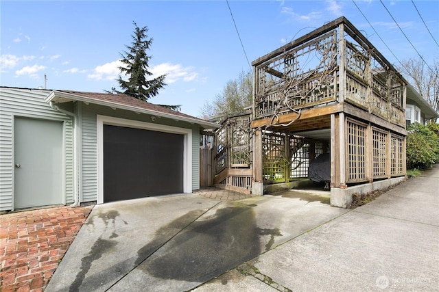 2011 E Cherry St, Seattle, WA 98122 - view of side of home with concrete driveway, an outdoor structure, a wooden deck, and stairway
