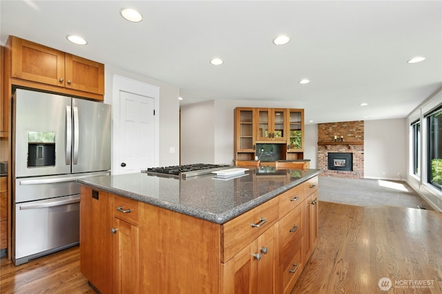 15102 93rd Pl NE, Bothell, WA 98011 - kitchen with stainless steel appliances, wood finished floors, recessed lighting, a kitchen island, and a fireplace