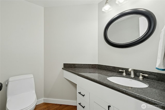 15102 93rd Pl NE, Bothell, WA 98011 - bathroom featuring toilet, vanity, baseboards, and wood finished floors