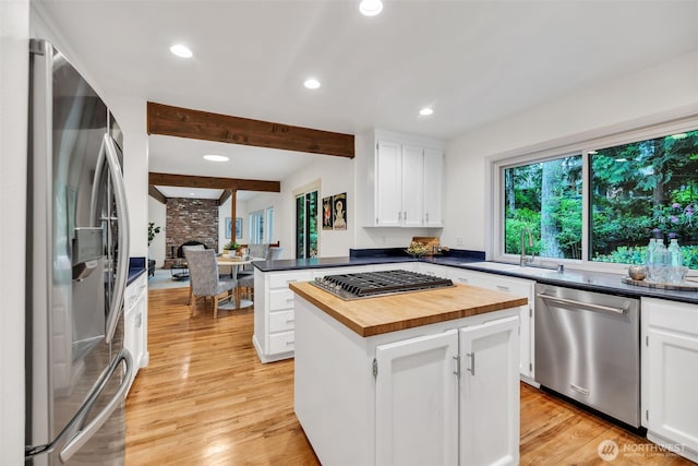 2714 Sahalee Dr E, Sammamish, WA 98074 - kitchen with stainless steel appliances, butcher block countertops, beam ceiling, light wood-style flooring, and recessed lighting