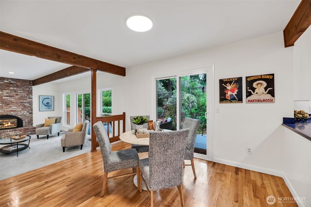 2714 Sahalee Dr E, Sammamish, WA 98074 - dining space with plenty of natural light, light wood finished floors, beamed ceiling, baseboards, and a fireplace