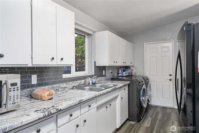 8909 Hipkins Rd SW, Lakewood, WA 98498 - laundry room with washing machine and clothes dryer and cabinet space