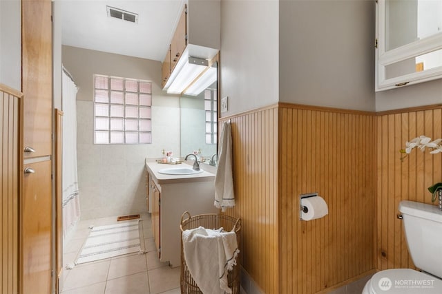 1001 Elm St, Centralia, WA 98531 - bathroom featuring toilet, vanity, a wainscoted wall, tile patterned floors, and a shower with shower curtain