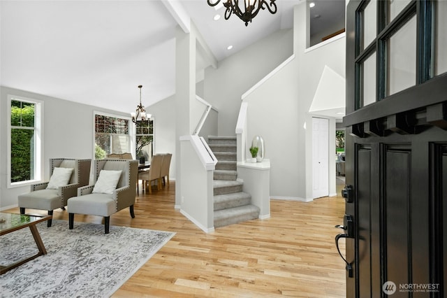 32910 NE 40th Pl, Carnation, WA 98014 - entrance foyer with a chandelier, light wood-style floors, stairway, baseboards, and high vaulted ceiling