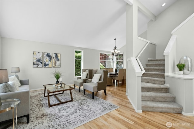 32910 NE 40th Pl, Carnation, WA 98014 - living area with a chandelier, stairway, lofted ceiling, wood finished floors, and baseboards