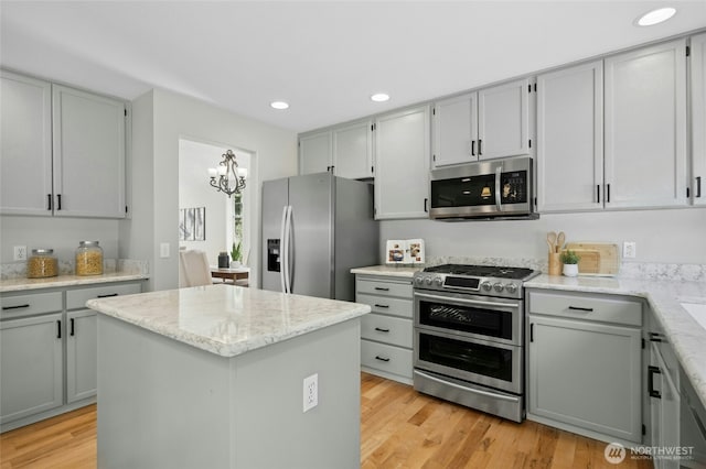 32910 NE 40th Pl, Carnation, WA 98014 - kitchen featuring appliances with stainless steel finishes, a chandelier, light wood finished floors, a center island, and recessed lighting