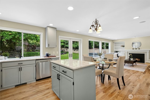 32910 NE 40th Pl, Carnation, WA 98014 - kitchen with stainless steel dishwasher, a sink, gray cabinetry, light wood-style flooring, and a center island