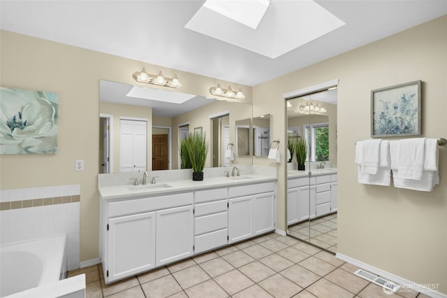 32910 NE 40th Pl, Carnation, WA 98014 - bathroom with a skylight, double vanity, a bath, tile patterned flooring, and a chandelier