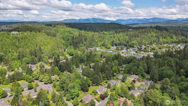 32910 NE 40th Pl, Carnation, WA 98014 - drone / aerial view of a heavily wooded area and a mountain backdrop