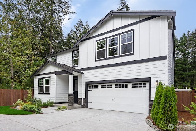 2417 Hyde Ct NE Unit 20, Olympia, WA 98506 - view of front facade with an attached garage, board and batten siding, driveway, and stone siding