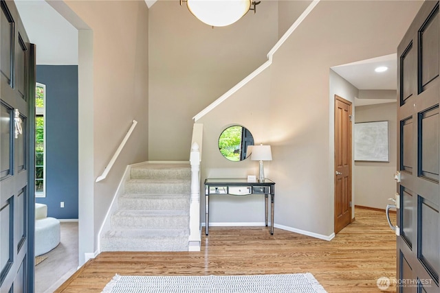2110 216th Pl NE, Sammamish, WA 98074 - foyer entrance featuring light wood-style floors, stairway, baseboards, and a towering ceiling