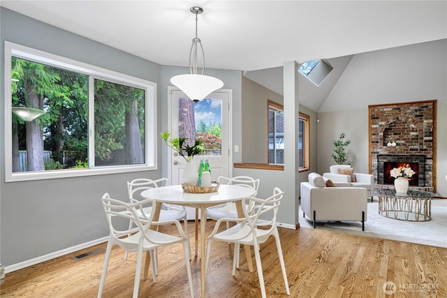 2110 216th Pl NE, Sammamish, WA 98074 - dining room featuring healthy amount of natural light, baseboards, wood finished floors, and vaulted ceiling