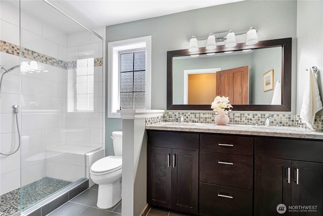 2110 216th Pl NE, Sammamish, WA 98074 - full bath featuring double vanity, toilet, a shower stall, decorative backsplash, and tile patterned floors