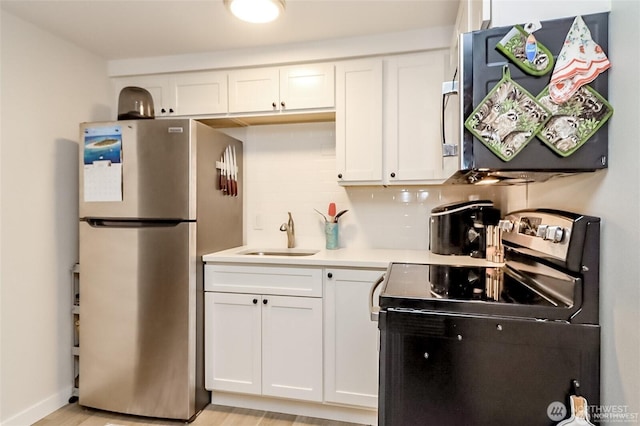 3834 175th Ave NE Unit G16, Redmond, WA 98052 - kitchen featuring stainless steel appliances, a sink, white cabinets, light countertops, and tasteful backsplash