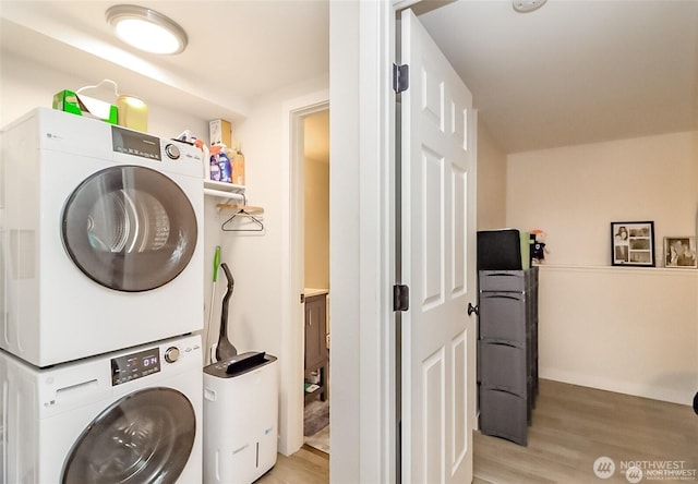 3834 175th Ave NE Unit G16, Redmond, WA 98052 - laundry room with stacked washing machine and dryer and light wood-style floors