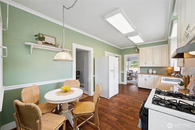2828 Sunset Dr, Bellingham, WA 98225 - kitchen featuring white refrigerator with ice dispenser, ornamental molding, tasteful backsplash, dark wood-type flooring, and white cabinetry
